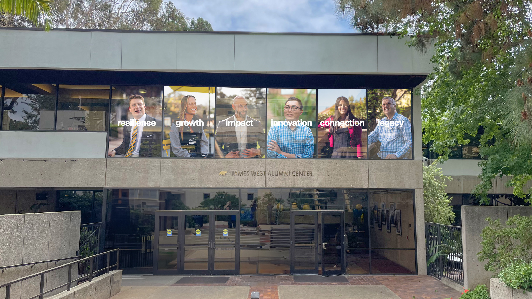 JWAC main entrance with Bruin Stories window graphics.